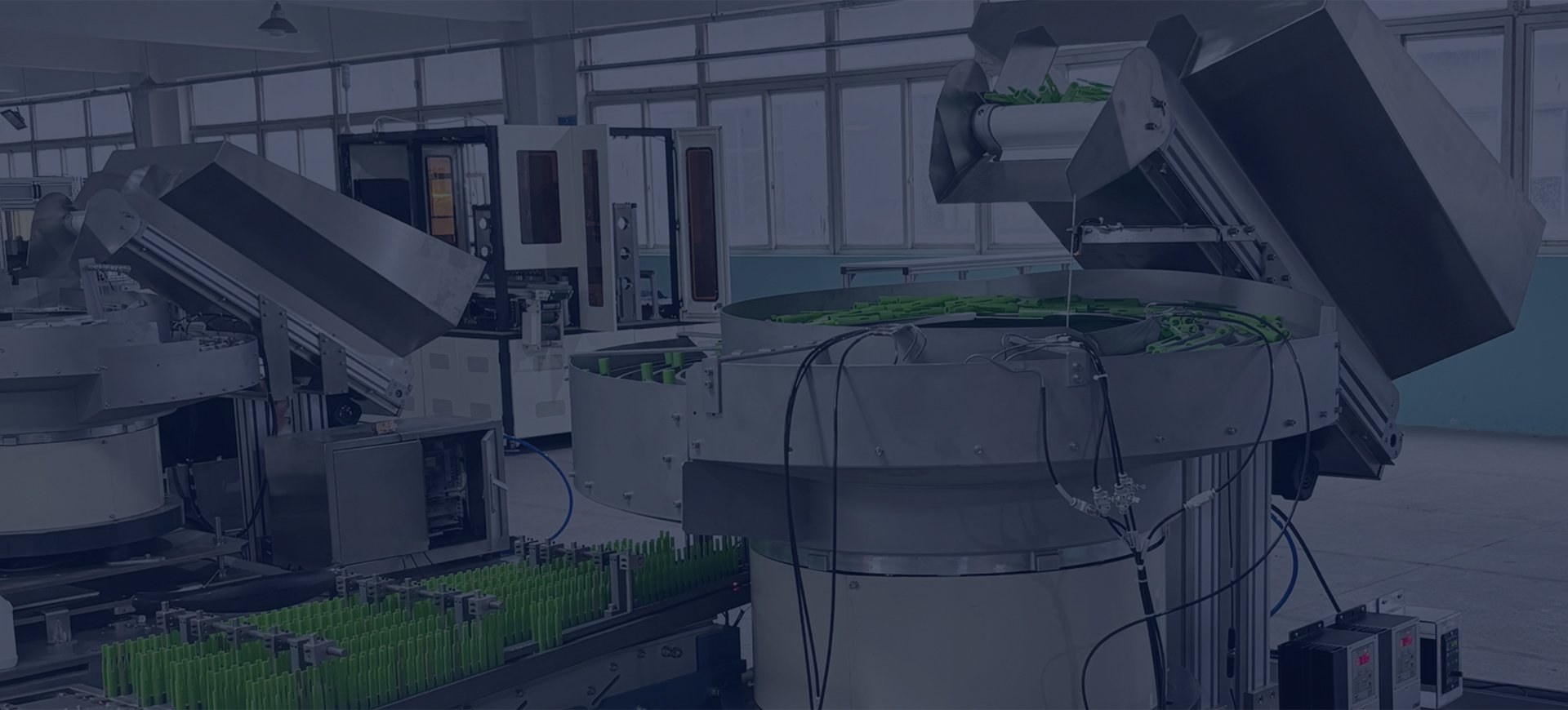 Industrial component feeding line with multiple vibratory feeders and elevators in production